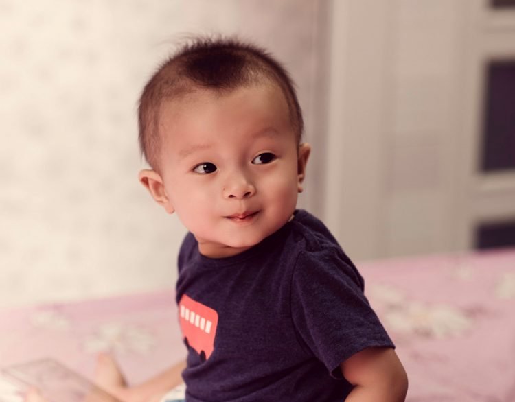 Baby looking at something not seen by the camera.